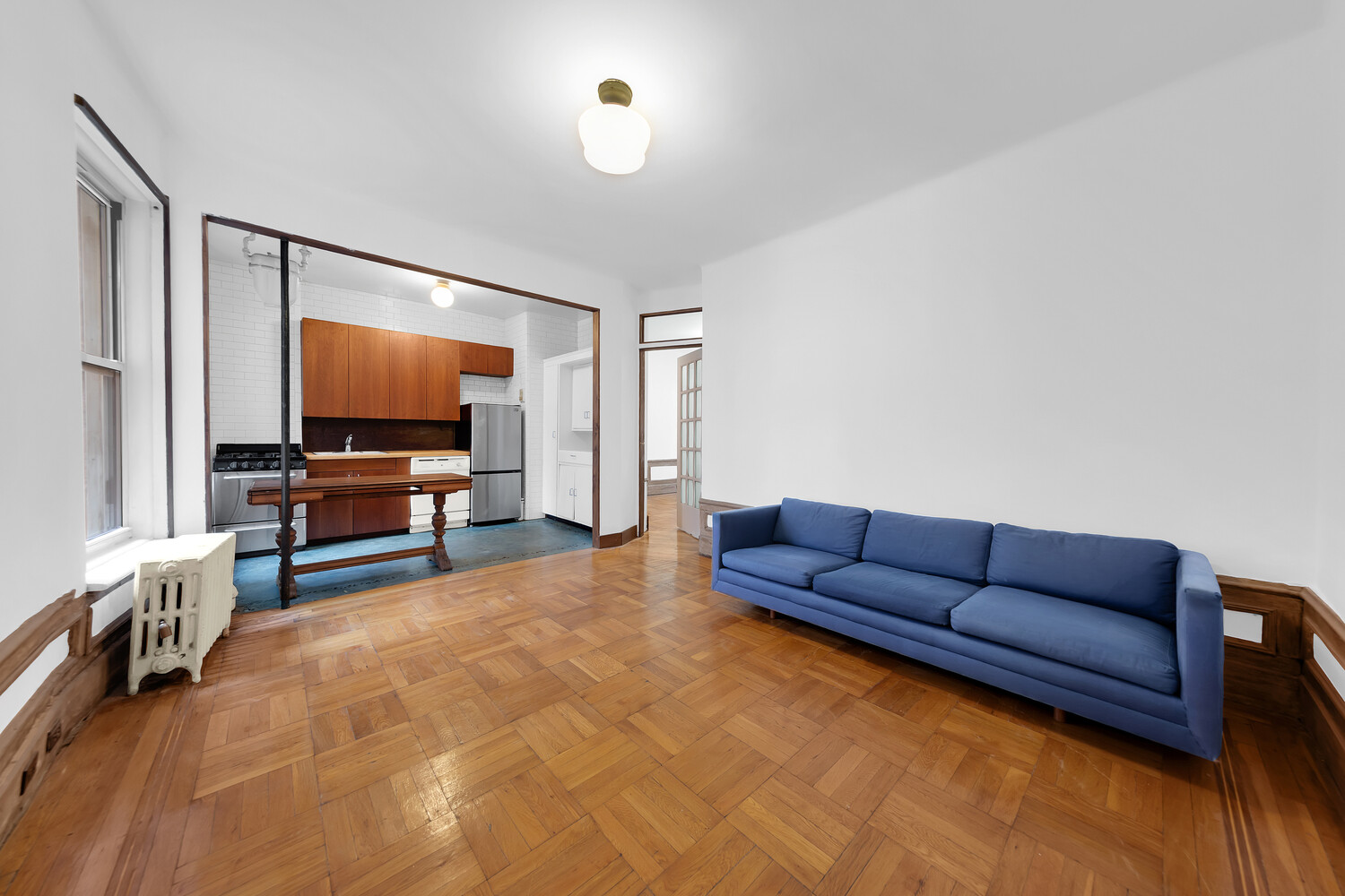 261 West 22nd Street, Unit 11 Manhattan, NY 10011 - Photo 6 of 10 a living room with furniture and a flat screen tv