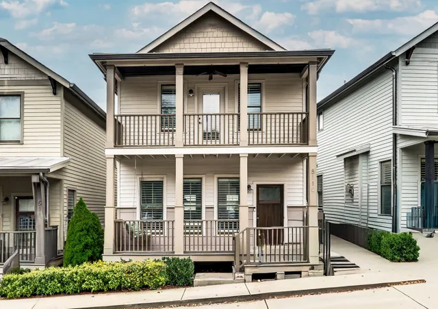 a view of a white house with large windows