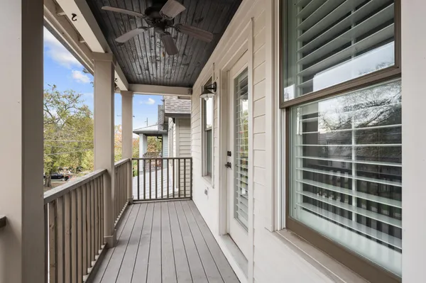 a view of a balcony with wooden floor and iron stairs