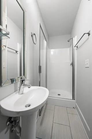 a bathroom with a sink a mirror and shower