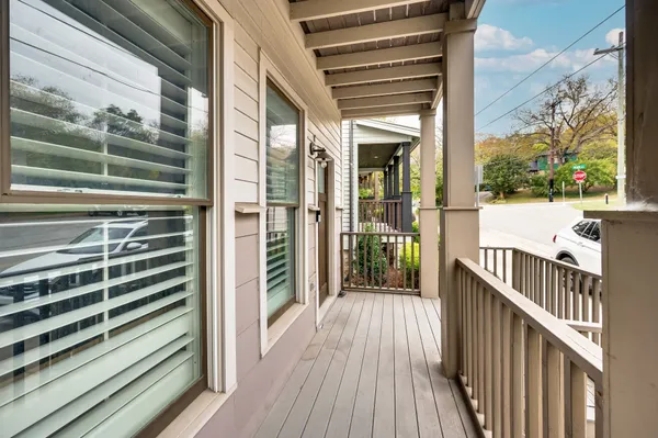 a view of a balcony with wooden floor