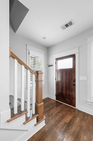 a view of a room with floor to ceiling window and wooden floor