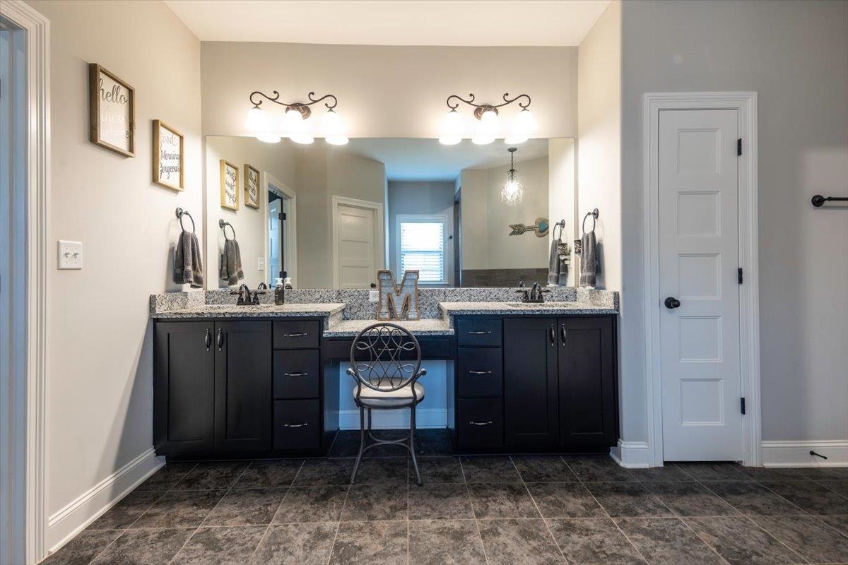 3328 Straw Bridge Road Olive Branch, MS 38654 - Photo 23 of 28 Dual vanities with integrated sinks, granite countertops, dark wood-finish cabinetry, and tiled flooring