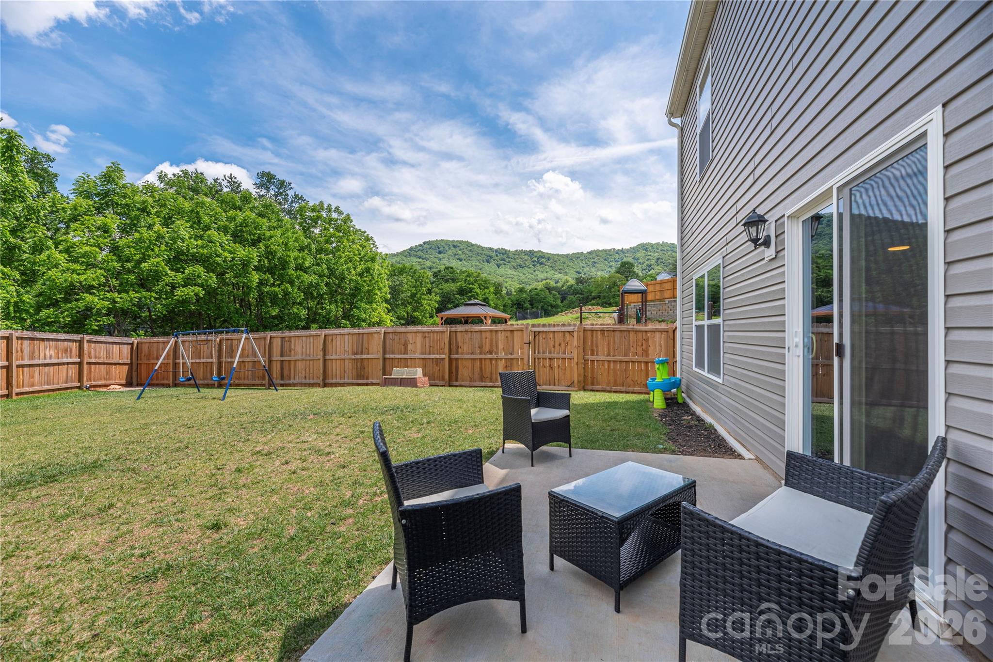 8 Madelyn Drive Clyde, NC 28721 - Photo 31 of 43 a backyard of a house with table and chairs
