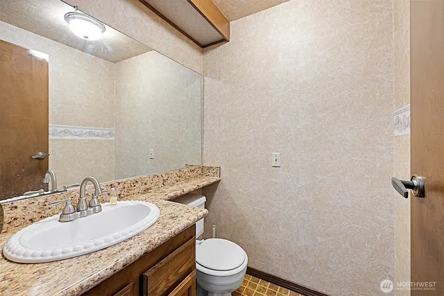 a bedroom with a large bed and a flat tv screen