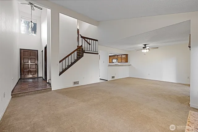 a view of an empty room with a fireplace
