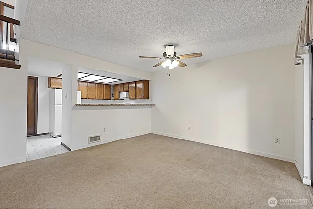 a kitchen with granite countertop a sink stainless steel appliances and cabinets