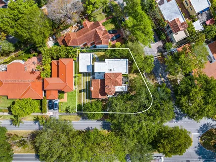 a view of a house with potted plants