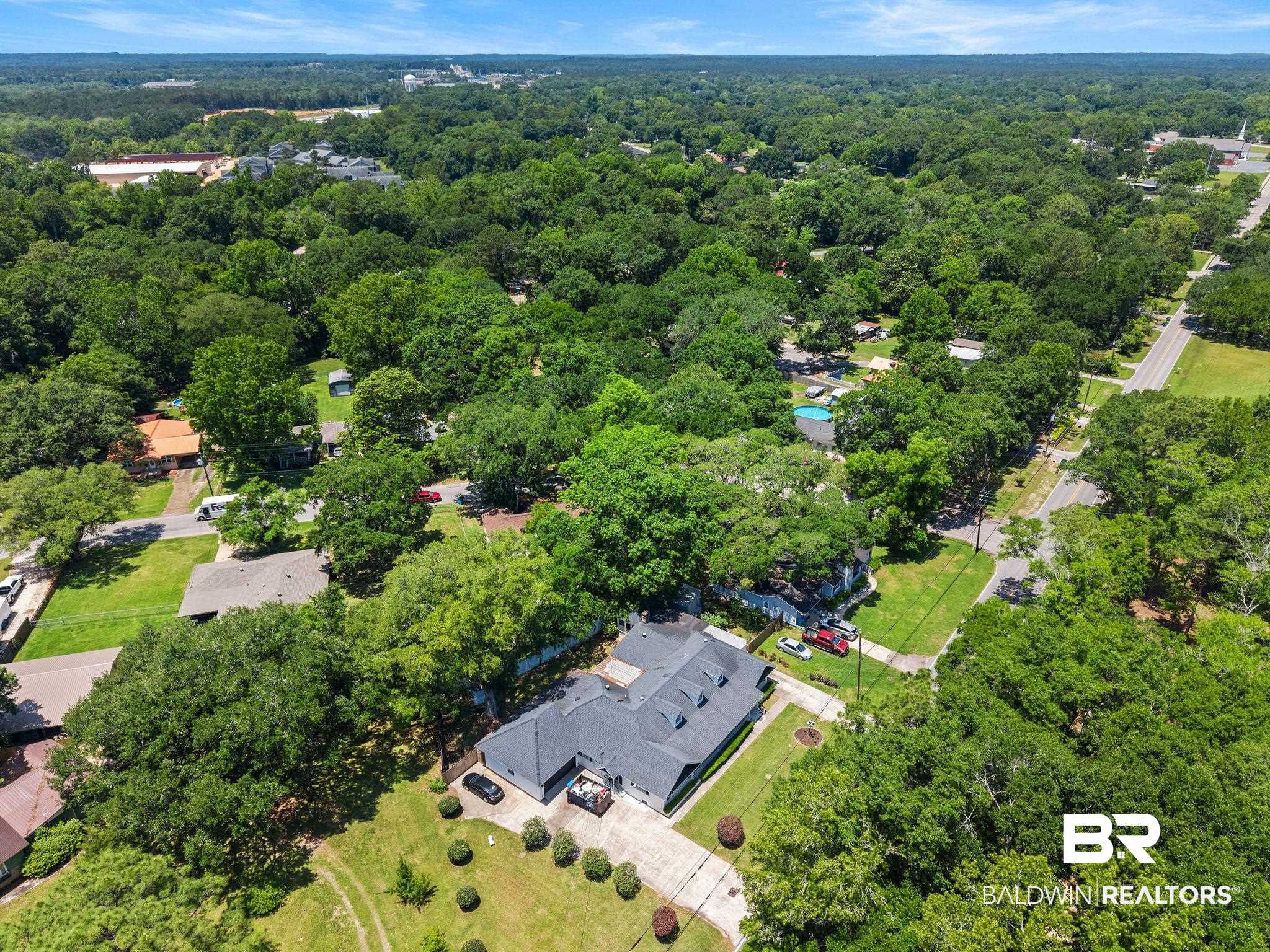 927 Cleveland Road Saraland, AL 36571 - Photo 78 of 80 Expansive property featuring a dark-shingled roof, mature trees, and a concrete driveway