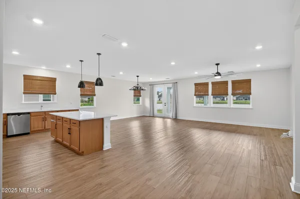 a kitchen with stainless steel appliances granite countertop white cabinets and a stove top oven