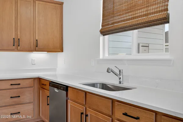 a bathroom with a shower sink and mirror