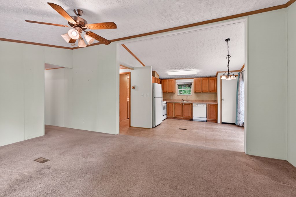 282 West Cherry Road Hayesville, NC 28904 - Photo 11 of 45 en empty room with windows and ceiling fan