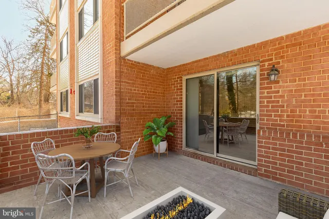 a view of a patio with table and chairs and potted plants