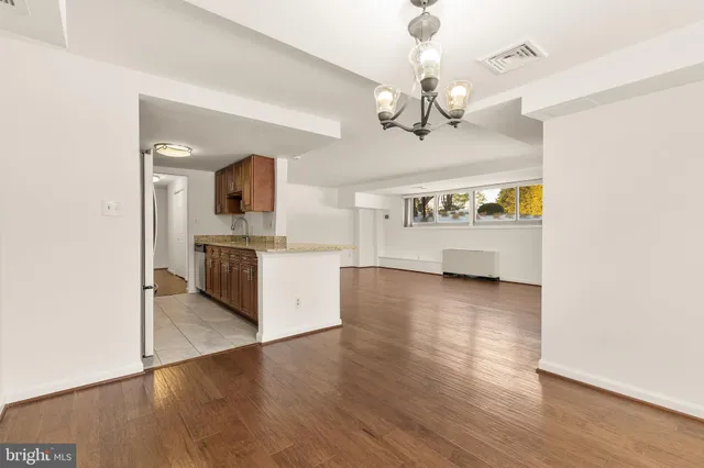 a view of a kitchen with a sink and wooden floor
