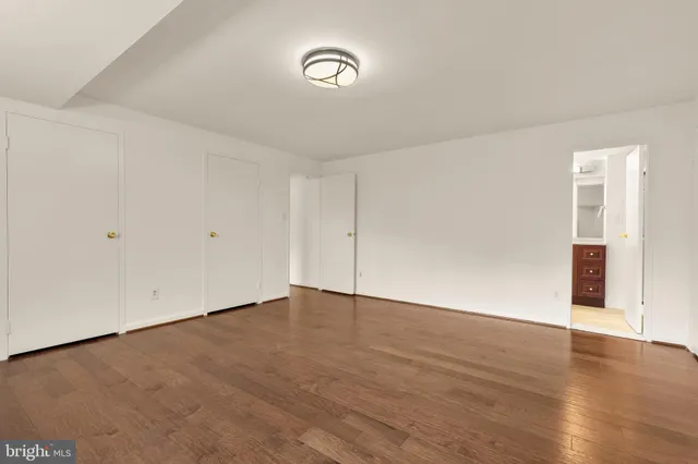 a view of an empty room with wooden floor