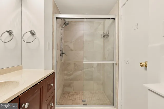 a bathroom with a shower and a sink