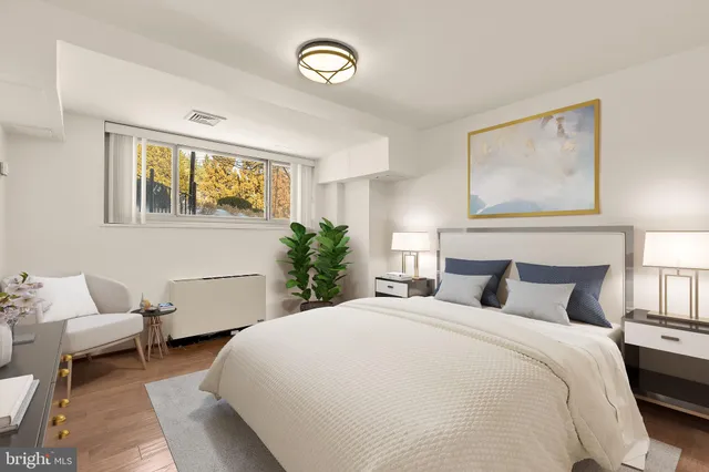 a bedroom with a large bed and a couch