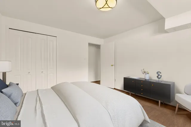 a bed room with a bed and a chair