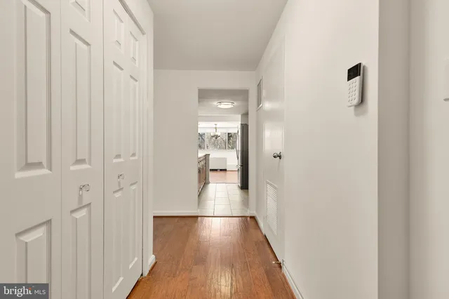 a view of a hallway with wooden floor and staircase