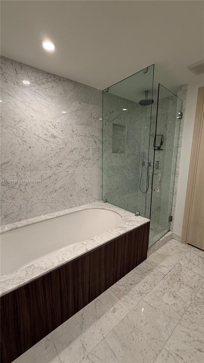 1000 Brickell, Unit 2014 Miami, FL 33131 - Photo 24 of 30 a bathroom with a bathtub and a shower
