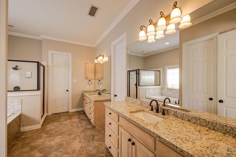 334 Farm To Market Road 2264 Decatur, TX 76234 - Photo 29 of 40 a spacious bathroom with a granite countertop sink mirror and a shower