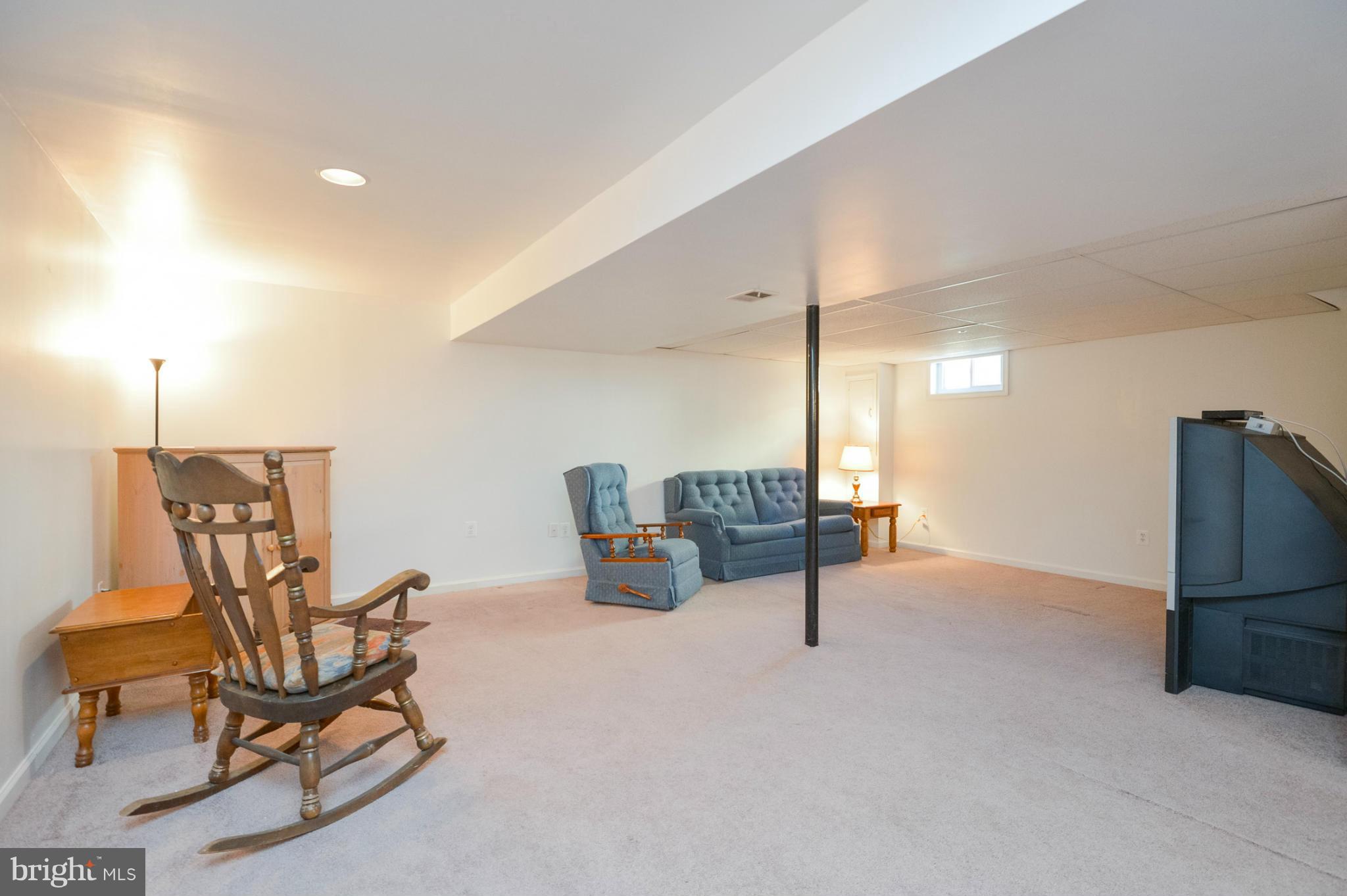 1927 Grant Road Halethorpe, MD 21227 - Photo 11 of 29 a living room with furniture a air conditioner and a window