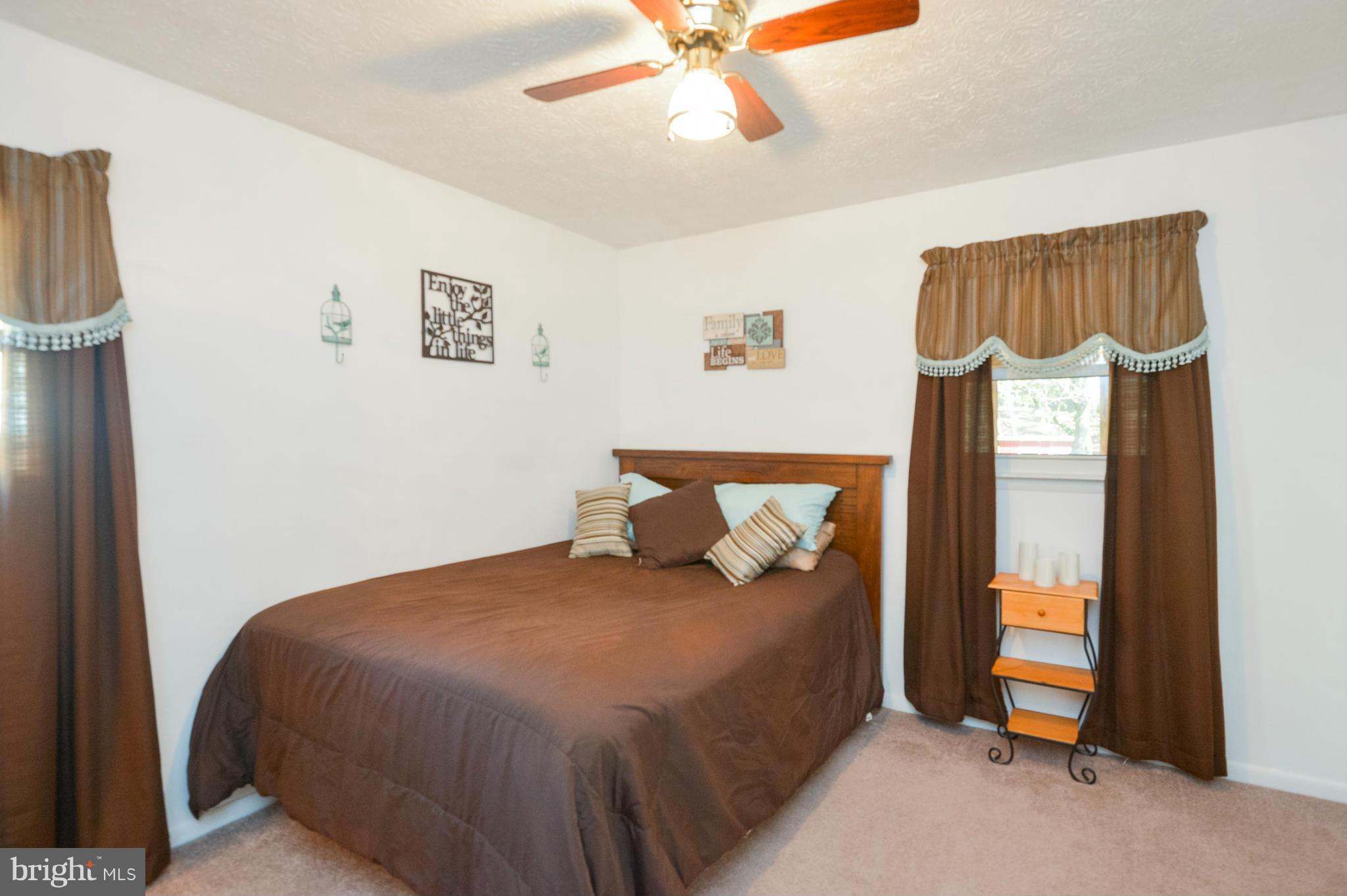 1927 Grant Road Halethorpe, MD 21227 - Photo 17 of 29 a bedroom with a bed and a chandelier