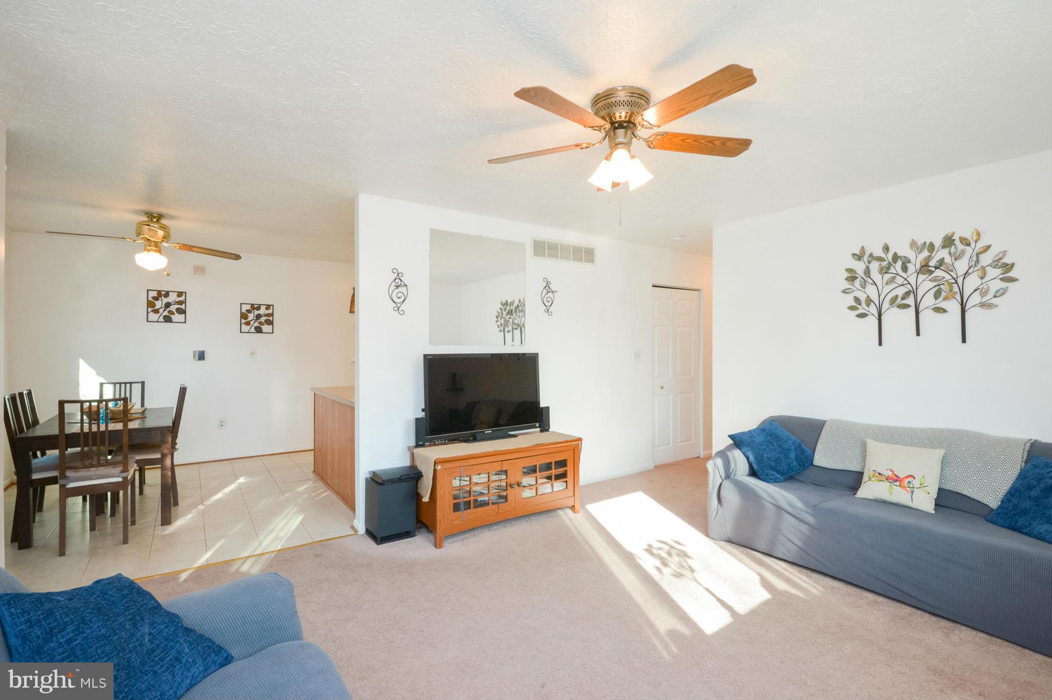 1927 Grant Road Halethorpe, MD 21227 - Photo 3 of 29 a living room with furniture and a flat screen tv with wooden floor