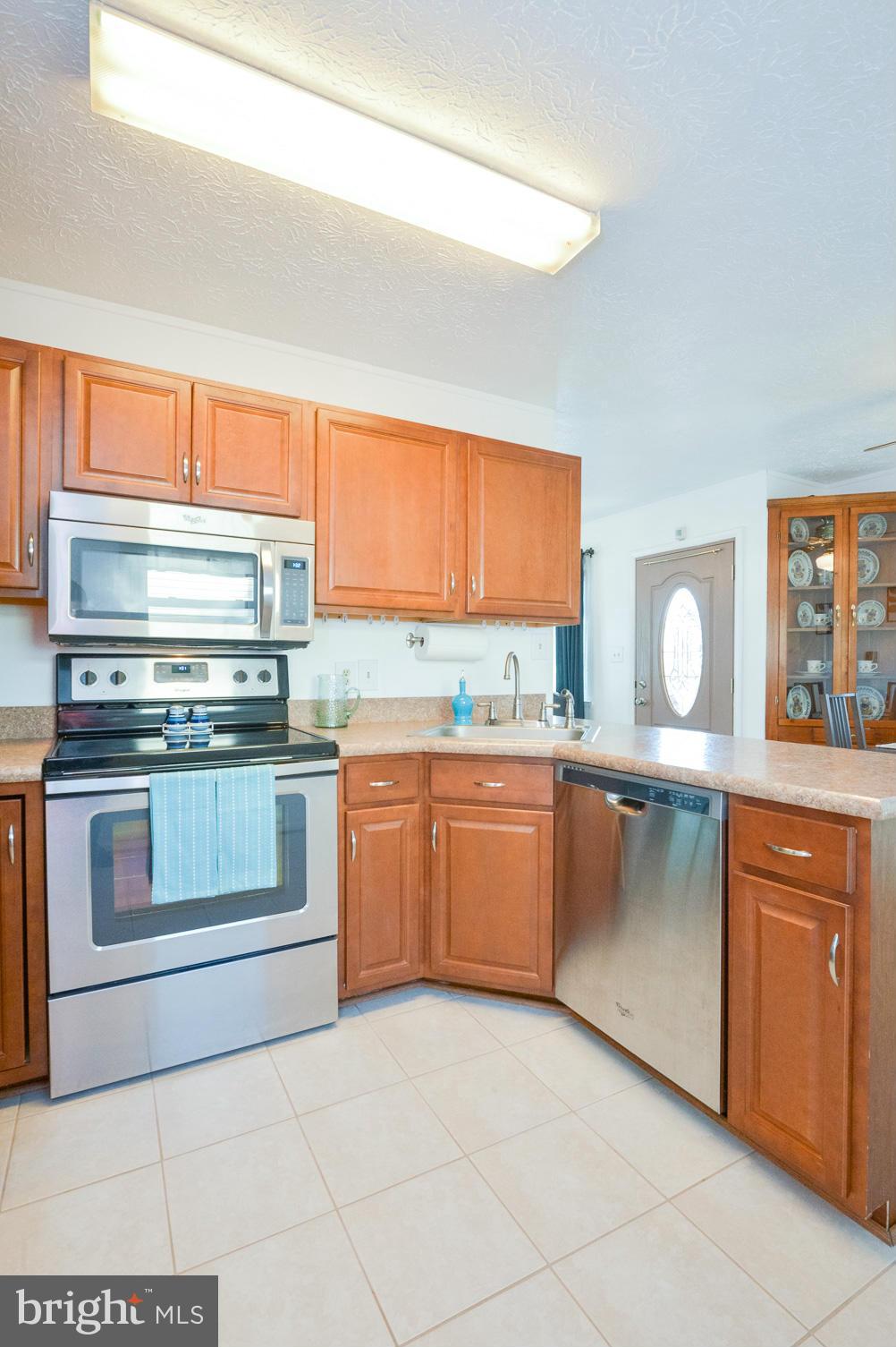 1927 Grant Road Halethorpe, MD 21227 - Photo 5 of 29 a kitchen with granite countertop a stove top oven sink and cabinets