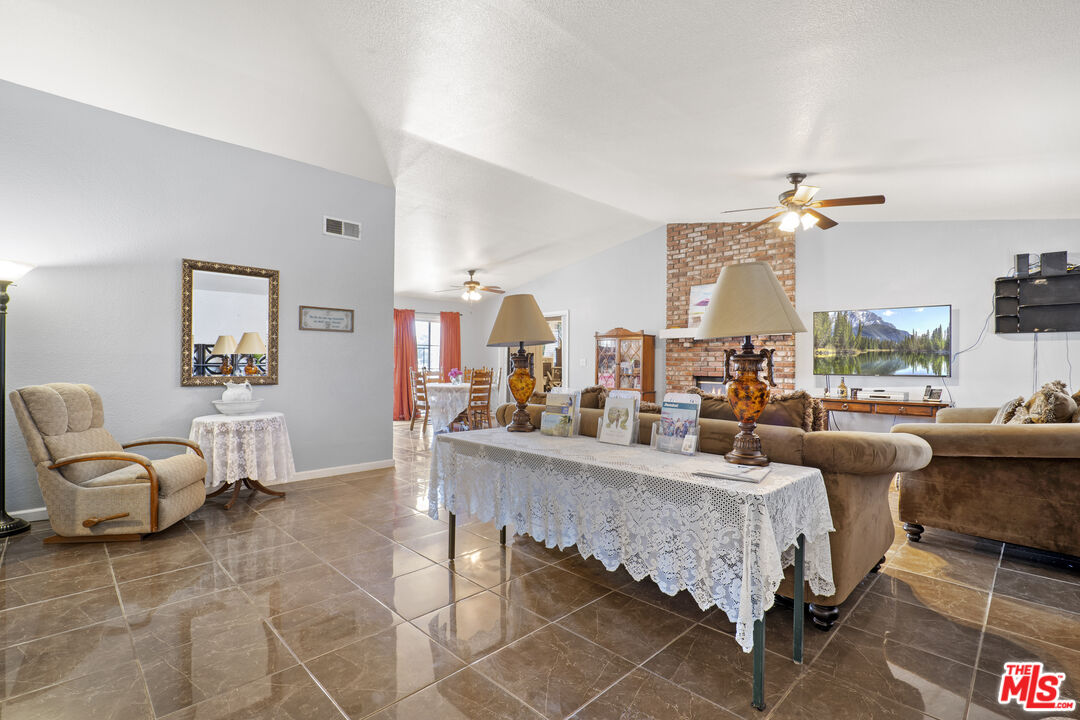 10647 East Ave R 10 Littlerock, CA 93543 - Photo 19 of 34 a living room with furniture and a chandelier
