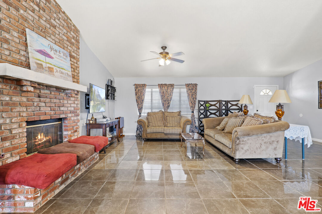 10647 East Ave R 10 Littlerock, CA 93543 - Photo 22 of 34 a living room with furniture and a fireplace