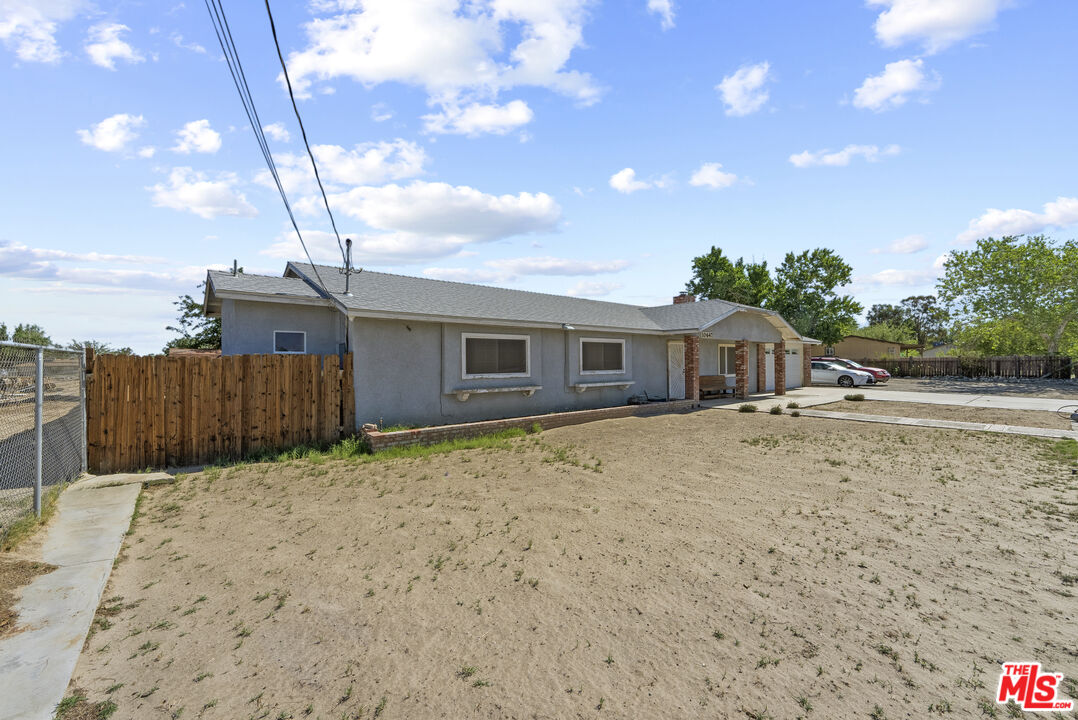 10647 East Ave R 10 Littlerock, CA 93543 - Photo 3 of 34 a front view of a house with a yard