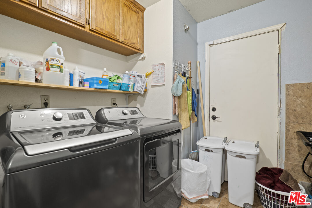 10647 East Ave R 10 Littlerock, CA 93543 - Photo 7 of 34 a bathroom with a stove a sink and a refrigerator