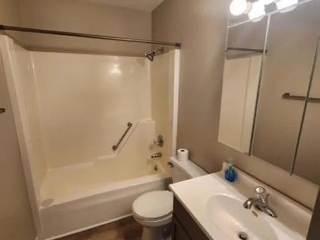 a view of a small space with wooden floor and a window