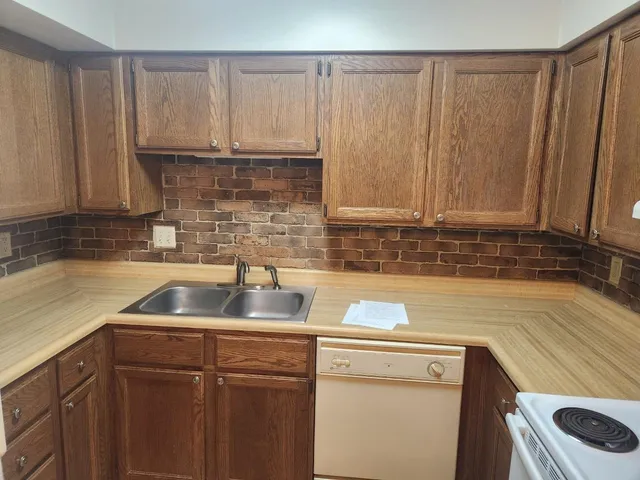 a kitchen with a refrigerator sink and stove