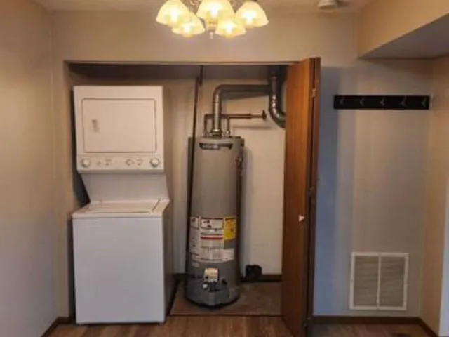 an empty room with wooden floor and closet