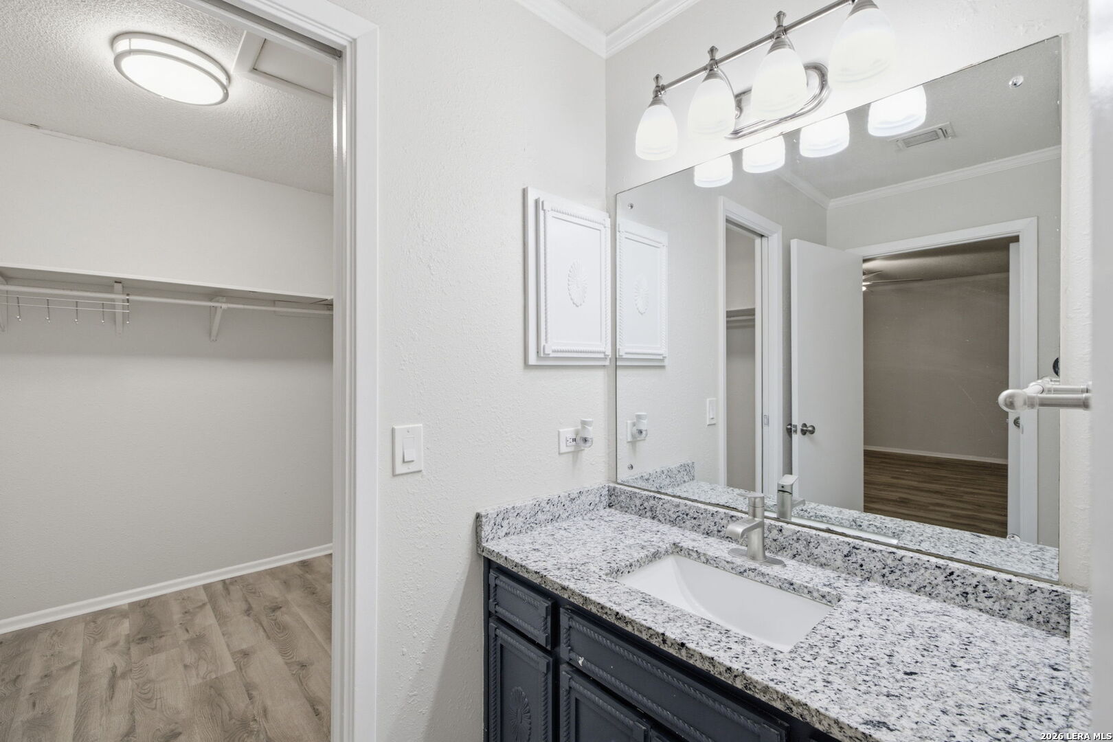 6106 Vance Jackson Road, Unit 15 San Antonio, TX 78230 - Photo 24 of 30 a bathroom with a granite countertop sink and a mirror