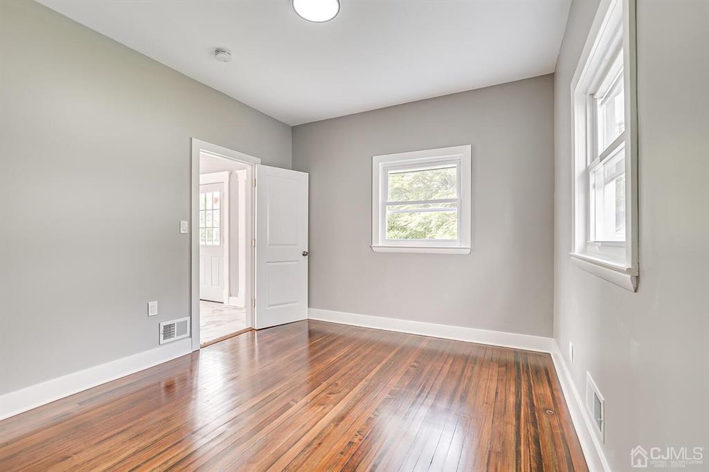 48 Johnson Place South River, NJ 08882 - Photo 19 of 34 an empty room with wooden floor and windows