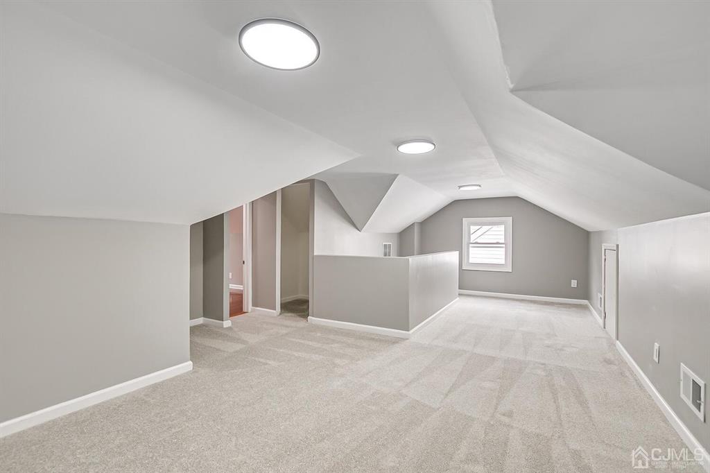 48 Johnson Place South River, NJ 08882 - Photo 24 of 34 a view of a big room with windows and chandelier fan