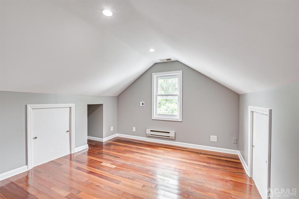 48 Johnson Place South River, NJ 08882 - Photo 25 of 34 an empty room with wooden floor and windows
