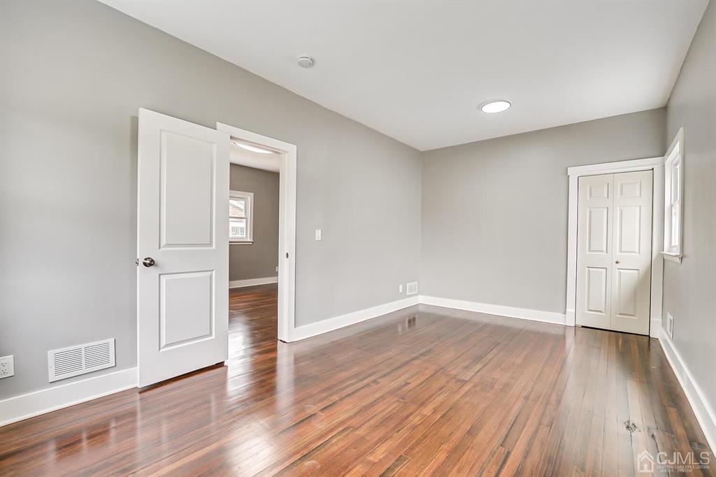 48 Johnson Place South River, NJ 08882 - Photo 9 of 34 wooden floor in an empty room with a window