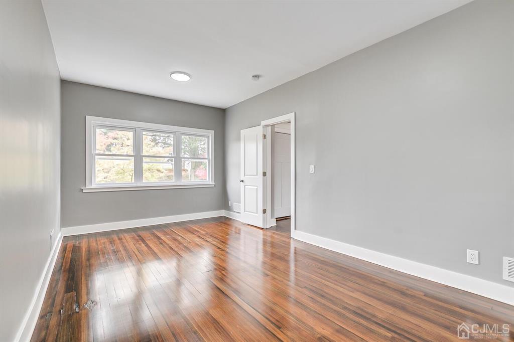 48 Johnson Place South River, NJ 08882 - Photo 10 of 34 a view of an empty room with wooden floor and a window