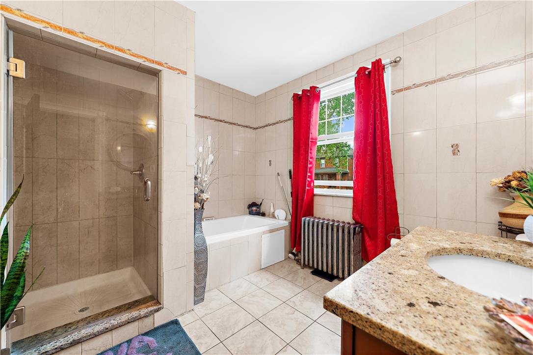 2055 Ferry Street Wilson, PA 18042 - Photo 12 of 21 This bright bathroom features a spacious walk-in shower and a large soaking tub.