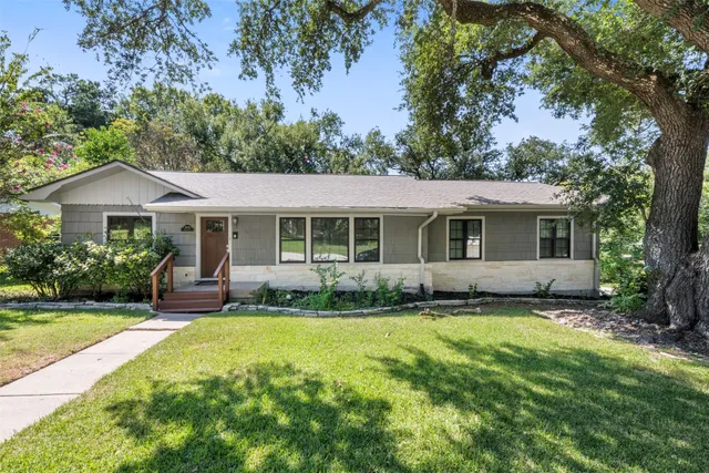 a view of a house with a yard and sitting area