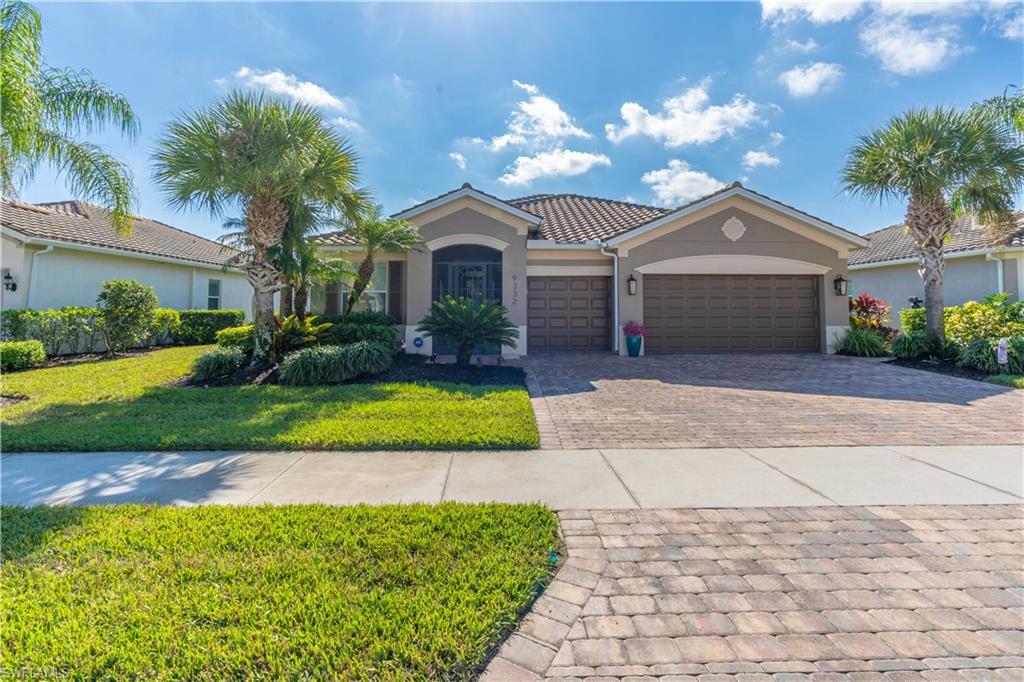 a front view of a house with a yard and garage