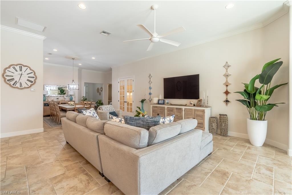 9332 Fieldstone Lane Naples, FL 34120 - Photo 11 of 41 a living room with fireplace furniture and a flat screen tv
