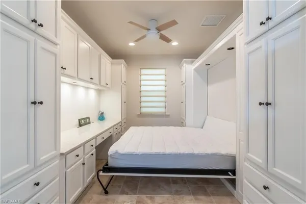 a bedroom with a bed and a window with the outer view