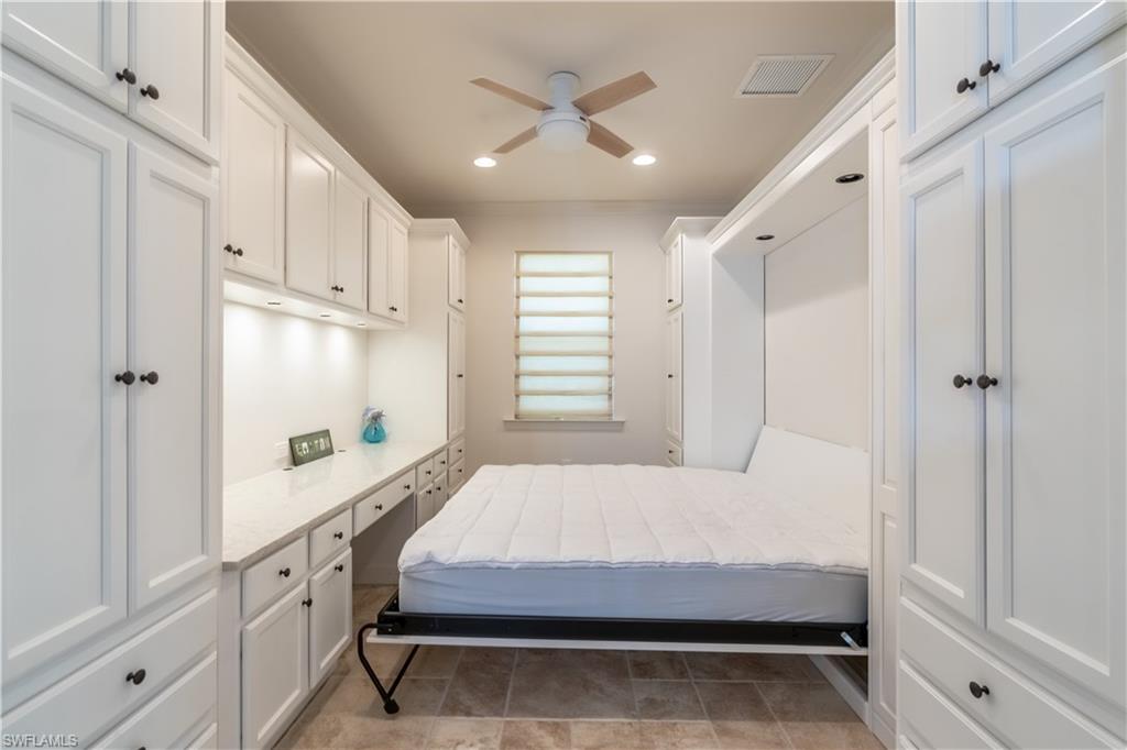 9332 Fieldstone Lane Naples, FL 34120 - Photo 18 of 41 a bedroom with a bed and a window with the outer view