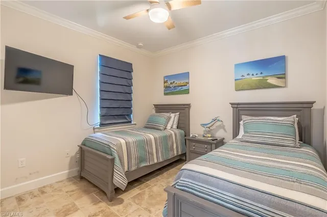 a bedroom with two beds and a chandelier