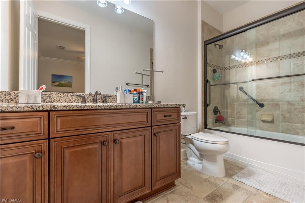 9332 Fieldstone Lane Naples, FL 34120 - Photo 20 of 41 a bathroom with a sink a toilet and shower